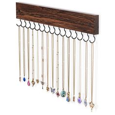 a wooden rack with many different necklaces hanging from it