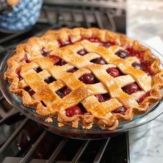 a cherry pie sitting on top of an oven