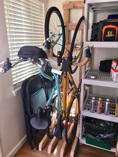 there is a bike that has been placed on the rack in the room with it's wheels up