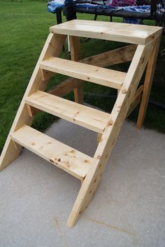 a wooden ladder sitting on top of a sidewalk