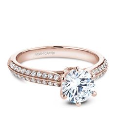 a rose gold engagement ring with diamonds on the band and a round cut diamond in the center