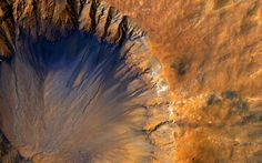 an aerial view of a large crater in the desert