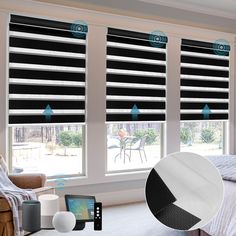 a bedroom with black and white roman shades on the windows, next to a bed