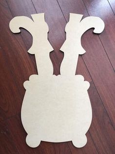 a cut out of paper sitting on top of a wooden floor