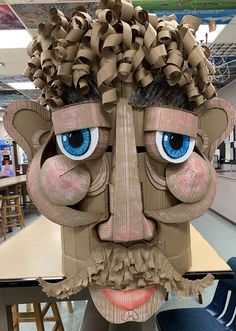 a cardboard sculpture of a man with blue eyes