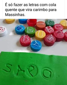 a green piece of paper with the word sao written on it and some colorful buttons