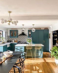 the instagram page shows an image of a kitchen with blue cabinets and wooden floors