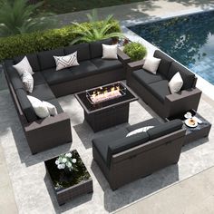 an outdoor living room with couches and fire pit in the center, next to a swimming pool