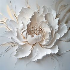 a large white flower with lots of gold in it's center on a light blue background