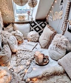 a room filled with lots of pillows and blankets on top of it's floor