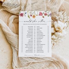 a wedding checklist with flowers on it sitting next to some burlap material