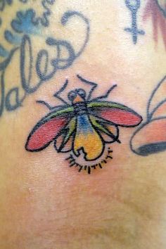 a close up of a tattoo on the back of a person's shoulder and chest