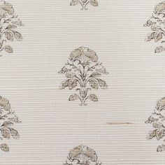 a white and brown wallpaper with an ornate design on the back half of it