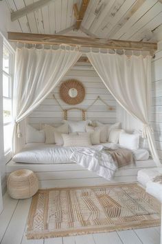 a bed with white sheets and pillows in a room next to a rug on the floor