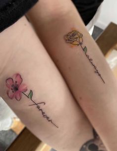 two people with matching tattoos on their legs, one has a flower and the other has a name