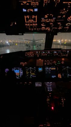 the view from inside an airplane at night with lights in the cockpit and on the ground