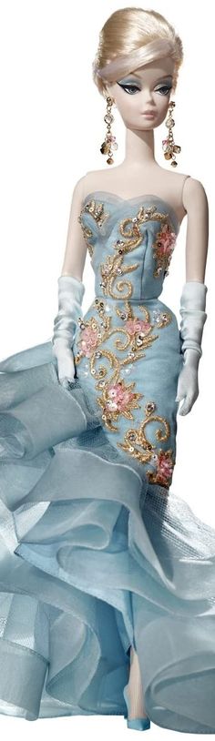 a barbie doll wearing a blue dress with gold and pink flowers on it's skirt