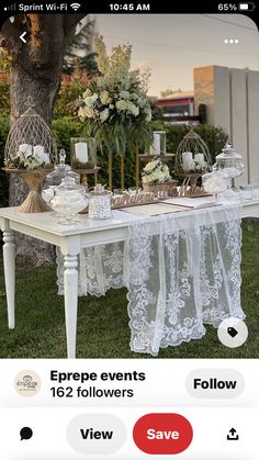 the table is set up with white flowers and candles