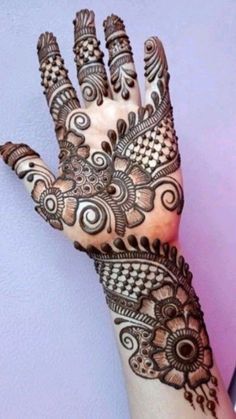 a woman's hand is decorated with hennap and intricate designs on it