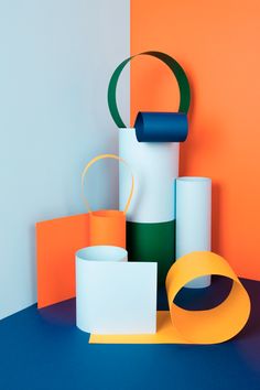 an assortment of different colored objects on a blue and orange surface with white, green, and yellow accents