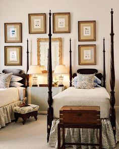 a bed room with a neatly made bed and pictures on the wall