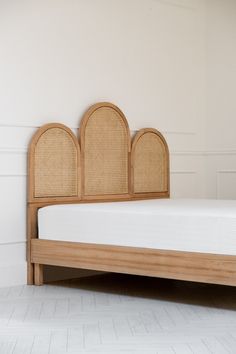 an image of a bed with wicker headboard and foot board on the floor