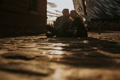 two people sitting on the ground next to each other