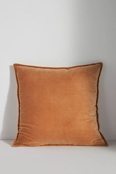 a brown pillow sitting on top of a white table