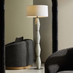 a lamp sitting on top of a table next to a chair