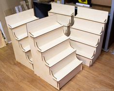 several cardboard boxes stacked on top of each other in the shape of shelves with no doors