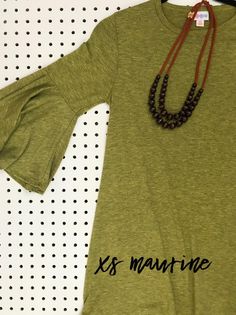 a t - shirt with the words k's marine on it and a beaded necklace