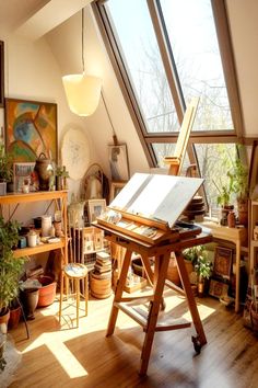 an artist's studio with lots of plants and art supplies in the window sill