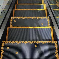 an escalator with yellow and black designs on it