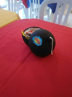 a black hat sitting on top of a red table