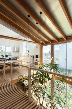 the interior of a modern house with wood and glass railings leading up to an open floor plan