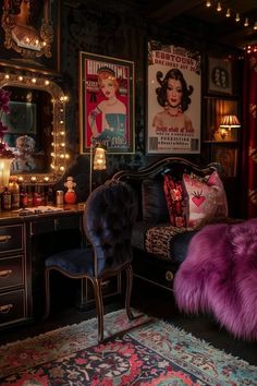 a bedroom decorated in black and purple with pictures on the wall, vanity mirror, chair, rug and lights