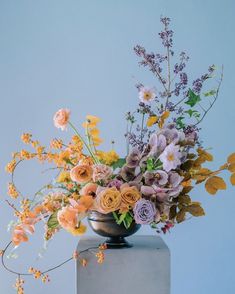 a vase filled with flowers sitting on top of a table