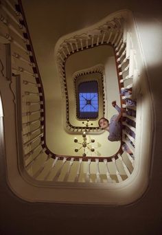 a person standing in the middle of a spiral staircase