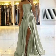 The Satin Sleeveless Front Slit Prom Dress is the epitome of sophistication and allure. Crafted from luxurious satin fabric, its sleeveless design exudes modern elegance, while the front slit adds a touch of allure and movement. Perfect for prom or any formal occasion, this dress ensures you'll make a statement with every step. Sage Green Prom Dress, Prom Dress Inspiration, Cute Prom Dresses, Long Prom Dresses, Maxi Dress Prom, Pretty Prom Dresses, A Line Prom Dresses, Green Prom Dress, Grad Dresses