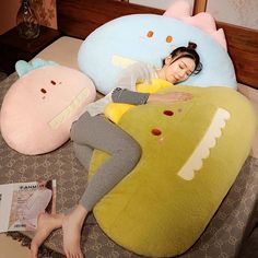 a woman laying on top of a bed next to two stuffed animals