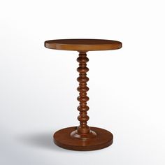 a small wooden table with a round top on a white background, it appears to be made from wood