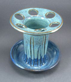 a blue and white vase sitting on top of a plate