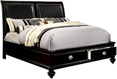 a black bed with two drawers underneath it