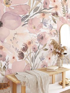 a floral wallpaper with pink flowers and greenery in the corner next to a mirror