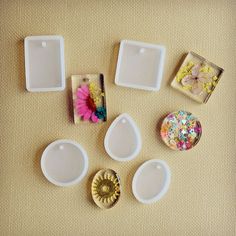 there are several different shapes and sizes of magnets on the table with flowers in them