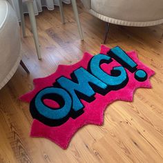 a pink rug with the word omg on it