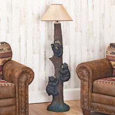 a bear lamp sitting on top of a wooden table next to two couches and a chair