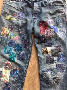 an old pair of jeans with colorful patches on them