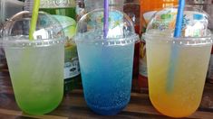 three different colored drinks sitting next to each other