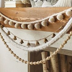 a wooden shelf with some bells hanging from it